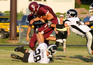 Alex Brehmer hurdles over a defender on his way to a touchdown.  Photo Credit/Steven Hosch