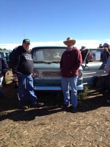Loren Swanson, left, and Steve Schlichting in front of one of the many vehicles that sold in Pierce this past weekend. Photo Credit/Jean Schlichting. 