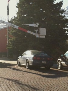 Terry Johnson is on the ground assisting Burt County Public Power's boom truck in replacing the lights on Oakland's Christmas Tree. Photo Credit, Denise Gilliland, Editor and Chief, Kat Country Hub.
