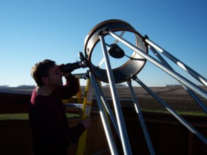 Cory Martin observing through the 17.5″ reflector at Fugman Observatory. Photo courtesy of Northeast Nebraska Astronomy Club.