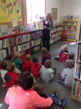 Oakland preschoolers enjoy a book being read by Oakland Library Director Rosa Schmidt. Photo Courtesy of Oakland Public Library. 