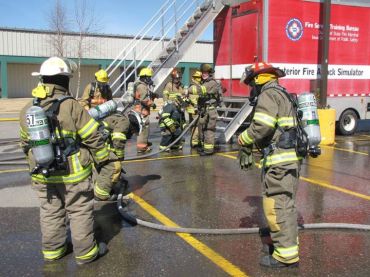 Susan Seery, white helmet and Nick Seery in the red helmet, attended fire school in Sioux City. Photo Courtesy of Susan Seery.