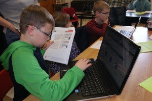 Brayden Anderson keeps track of the instructions as he logs into the on-line Livestock Quality Assurance website for training this year.  All 4-H and FFA members will need to complete 3 modules in the correct age division by June 10 in order to be eligible to show livestock including poultry and rabbits at any fairs this year. Photo Credit/Mary Loftis.