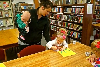 Paisley Peterson made her flower with some assistance from her mom, Brooke, holding her baby sister Hadley. Photo Credit/Denise Gilliland, Editor and Chief, Kat Country Hub.