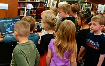 Oakland-Craig preschoolers watching the hummingbirds on the lap top at Oakland Public Library. Photo Credit/Denise Gilliland, Editor and Chief, Kat Country Hub.