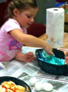 Hilary is rolling the egg in colored shaving cram. Photo Credit/Denise Gilliland, Editor and Chief, Kat Country Hub.