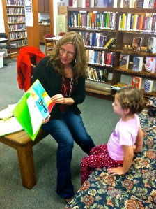 Library Director Rosa Schmidt reading an Easter story to Hilary Ray. Photo Credit/Denise Gilliland, Editor and Chief, Kat Country Hub.