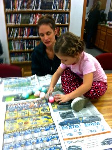Hilary with the eggs after wiping off the colored shaving cream. Her mom Nikki is helping her choose which ones to take home. Photo Credit/Denise Gilliland, Editor and Chief, Kat Country Hub.