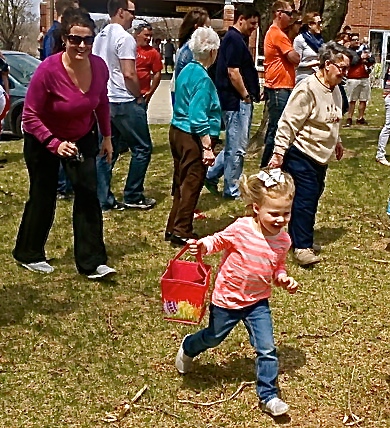 Paisley Peterson is in pursuit of candy filled Easter Eggs, with her mom, Brooke, following behind her. Photo Credit/Denise Gilliland, Editor and Chief, Kat Country Hub. 