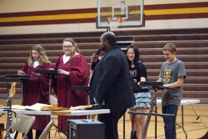  4404-The Northeast iPad Ensemble was featured during the concert.  Here you see the iPad Ensemble performing "Ice, Ice, Baby" by Vanilla Ice. L-R- Amelia Schlichting, Jessie Mutum, Shyanne French (covered up by Mr. Mayo), Sophie Hsu, and Jacob Swanson. Photo Courtesy of LDNE.