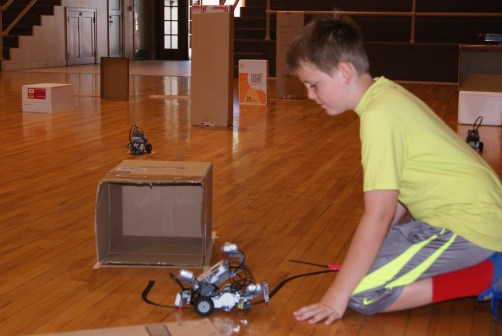 Miles Pearson of Oakland proudly demonstrated his robot as it follows the black tape line and parks in the “garage” just like he programmed it to do during the Razzle Dazzle Robotics Camp last week. The robotics workshop was conducted by UNL Extension Educator, Carroll Welte assisted by summer intern, Nick Bohannon.