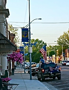 Bill Hultquist, one of the American Legions members and a veteran, placed a flag on Oakland's Main Street. Photo Credit/Denise Gilliland, Editor and Chief, Kat Country Hub.