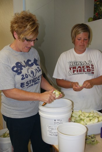 Jennifer Voskamp and Molly Willing core apples for apple pie during the 4-H Pie Day I. These pies will be enjoyed in the 4-H Kitchen during the Burt County Fair.  Photo Credit/Mary Loftis.