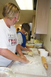 Molly Willing and Susan Skinner roll pie dough at the 4-H pie day. Photo Credit/Mary Loftis.
