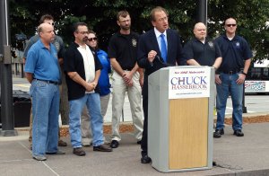 Chuck Hassebrook with law enforcement officials. Photo Courtesy of Chuck Hassebrook's office. 
