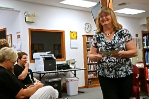 Mary Connealy hands out bookmarks, etc. to those attending to hear her speak on her writing career. Photo Credit/Denise Gilliland, Editor and Chief, Kat Country Hub.