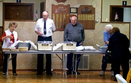 Lavonne Martin, from left, Leonard Erickson, Norm Cull and Hilda Benne, partially hidden, serve those attending the Veterans Day BBQ on Sunday. Photo Credit/Denise Gilliland, Editor and Chief, Kat Country Hub.