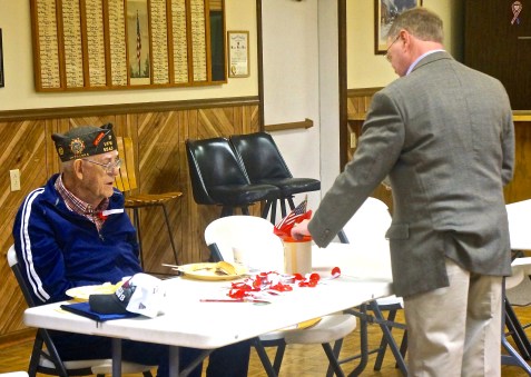 Jim Moseman, son of Willmer and Millie Moseman, gives Bill Taylor a donation for a poppy. Photo Credit/Denise Gilliland, Editor and Chief, Kat Country Hub. 