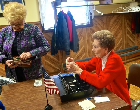 Millie Moseman, right, greeted Marlene Lindstrom, paying for her lunch at the BBQ. Photo Credit/Denise Gilliland, Editor and Chief, Kat Country Hub. 