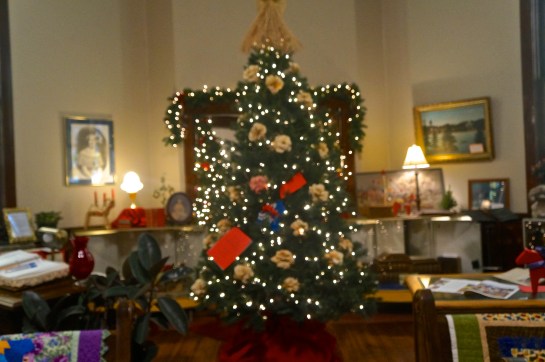 Tom Wallerstedt, curator at the Swedish Heritage Center, has been busy decorating the center for Christmas. The tree has been completed, decorated with Swedish Dala horses and ornaments Tom makes himself from corn husks. Photo Credit/Denise Gilliland, Editor and Chief, Kat Country Hub.