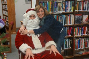 Oakland Library Director, Rosa Schmidt, gives Santa a hug, thanking him for coming from the north pole  to visit with the kids at the library. Photos credit of Denise Gilliland, Editor and Chief, Kat Country Hub.