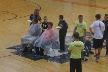Braylon Anderson, behind Joe Anderson, and Landon Reinert, behind Kris Reinert, anxiously await throwing a pie in their parents' faces. Photo Credit/Denise Gilliland, Editor and Chief, Kat Country Hub.