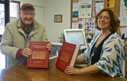 Russel Lang of rural Craig visited the Oakland Public Library donating two volumes of books to Oakland Library Director for patrons to enjoy. The books were compiled by Alex Meyer of the Scribner  area, covering historical events, families, businesses, etc. of the Uehling, Hooper, Scribner and surrounding areas. Photo Credit/Denise Gilliland, Editor and Chief, Kat Country Hub. 