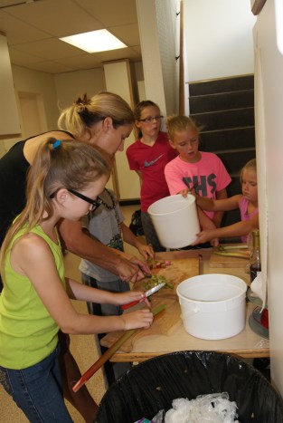 The rhubarb cutting crew concentrate on their job. Helping cut rhubarb were: Alex Davis, Molly Trotter, Parke Loftis (hidden) Hayley Niewohner, watching and Avry and Brennan Trotter. Photo Credit/Mary Loftis