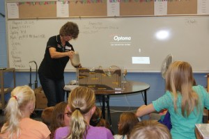Mary Loftis, Nebraska Extension Associate demonstrates how the groundwater flow model works in Holly Loftis’s 5th grade science classes in Tekamah. The group also covered the importance and quantity of water in their bodies and the world, the hydrologic (water) cycle, and conservation. Photo taken by Holly Loftis.