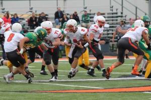 OC quarterback Cole Mitchell tries to find some running room against Bergan. Photo Credit/Cheri Droescher. 