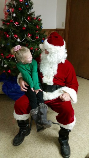 Paisley Peterson is all smiles sitting on Santa's lap. Photo Credit/Brooke Peterson.