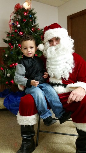 Bowen Perez was happy to see Santa at the Vets Building in Oakland. Photo Credit/Brooke Peterson