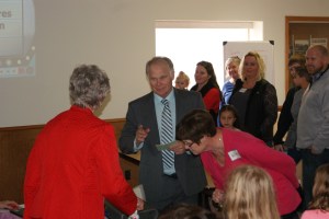 Craig Family Feud” host Steve “Harvey” Loftis asks the face off question to Phyllis Schmidt and Dawn Anderson while the Anderson Family looks on in the background during the Craig Parish Valentine Dinner. Photos by Katie Rieck