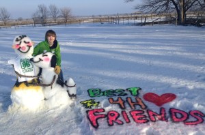 Cody Bachtell is pictured with the snow sculpture he created for the contest. Photo Credit JoAnn Bachtell. 