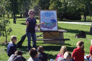 Mary Loftis, Extension Associate in Burt County explains the Water Cycle to this group of 6th grade students during the Sixth Grade Conservation Day at Summit Lake. – photo by Jennifer Hansen    